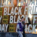 People walk past Black Friday sale signs - ANSA/EPA/ADAM VAUGHAN