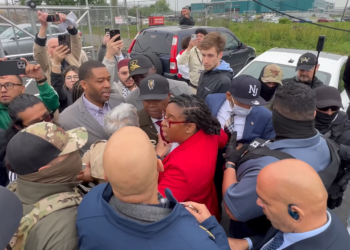 Mayor Baraka (center, wearing cap and red tie) being shielded by other government officials and protesters as ICE officers try to arrest him (YouTube screenshot: @NJSpotlightNews)